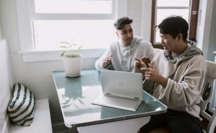 Two discussing on laptop